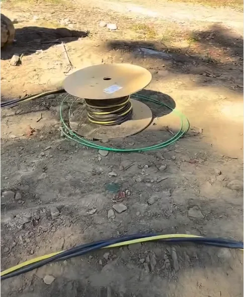 Underground electrical feed in an open trench